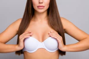 straight haired girl wearing and touching her white bra 300x200 1